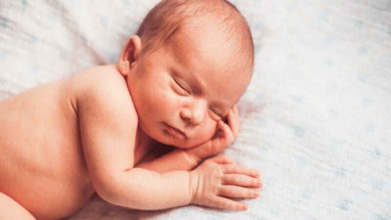 cute-baby-sleeping-with-hands-under-head