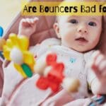 Are-bouncers-bad-for-babies-with-cute-kid-smiling-while-sitting-in-bouncer