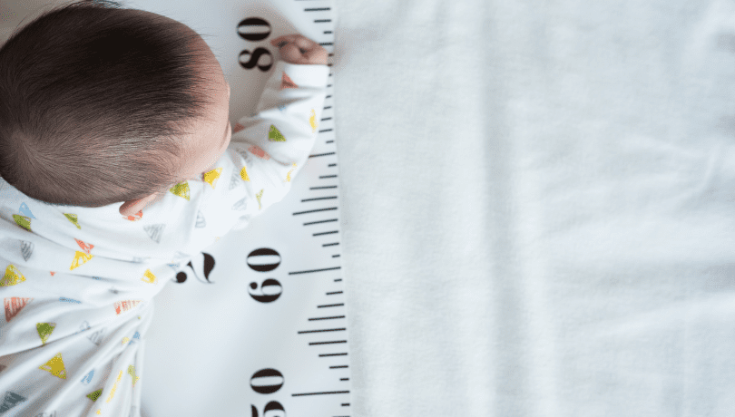 baby-on-their-tummy-sitting-on-a-measuring-sheet