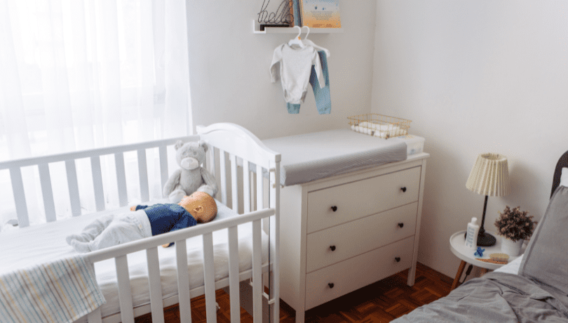 baby-in-a-crib-placed-in-a-nursery-with-baby-accessories