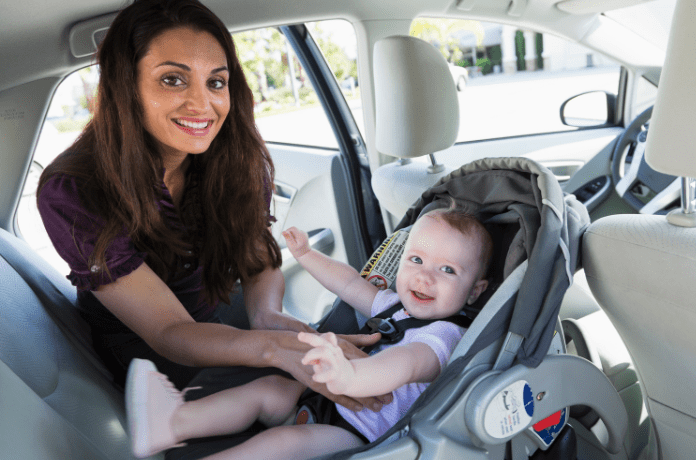 mother-securing-baby-in-a-rear-facing-infant-car-seat