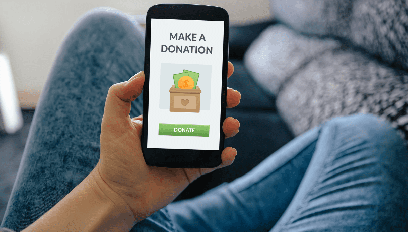 person-holding-smartphone-that-shows-a-donation-button-on-screen