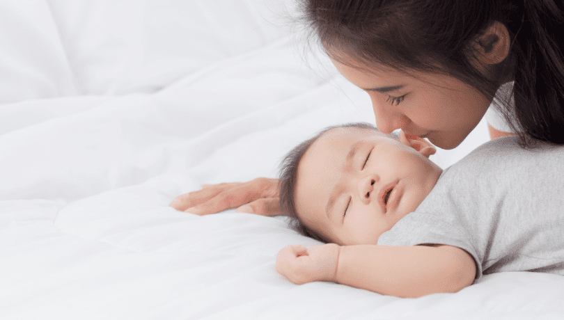 asian-mother-soothing-sleeping-baby