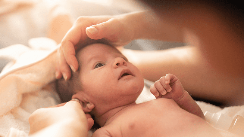 cute-newborn-baby-looking-at-mother