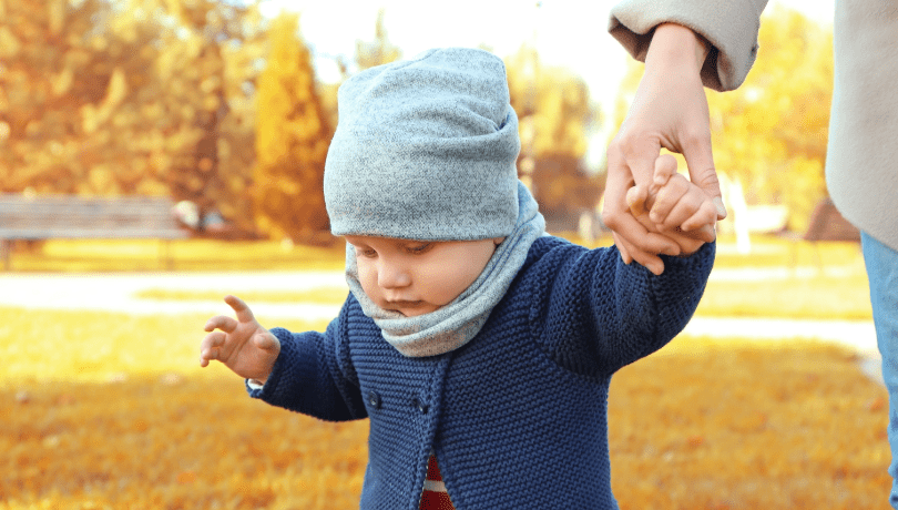 mother-with-her-baby-walking-in-the-park-hand-in-hand