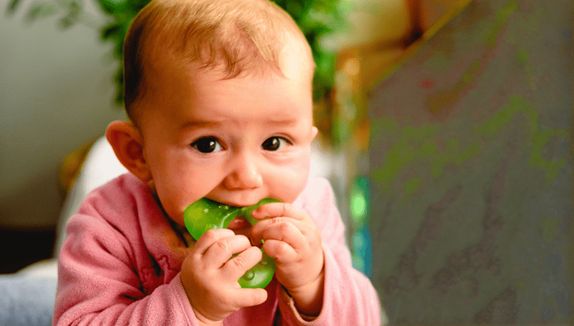 white-baby-chewing-on-a-teething-toy