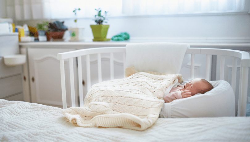 white-newborn-baby-sleeping-in-a-cosleeper-bassinet