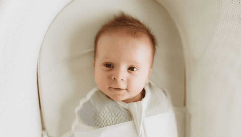 cute-swaddled-baby-lying-down-on-a-bassinet