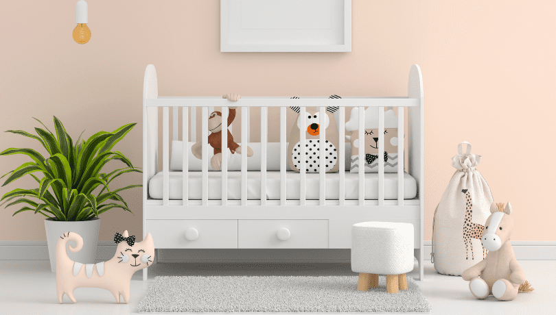 white-height-adjustable-crib-with-drawers-and-toys