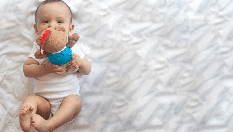 7-month-old-baby-playing-with-stuffed-toy