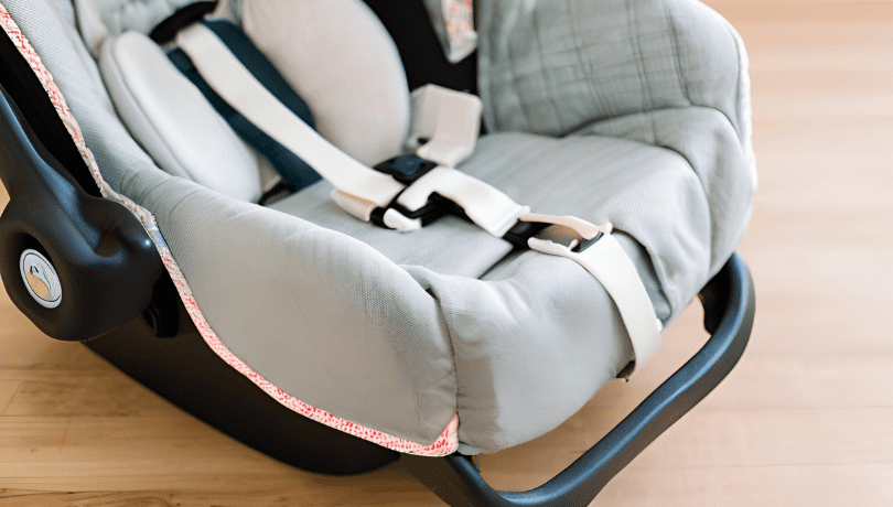 infant-car-seat-placed-on-a-wooden-floor