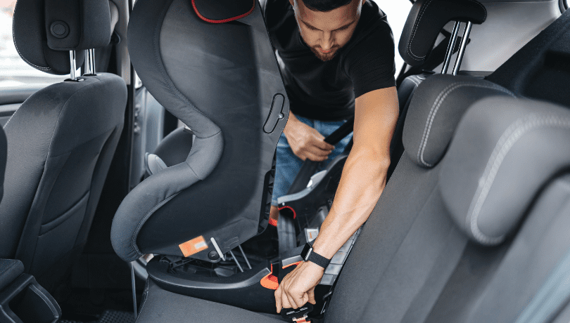 man-securing-infant-car-seat-using-the-vehicle-seatbelt