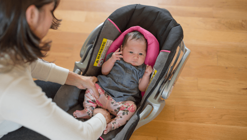 mom-buckling-baby-into-infant-car-seat