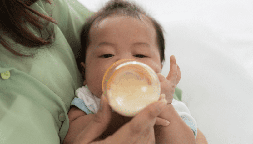 mother-feeding-newborn-baby-with-milk-bottle