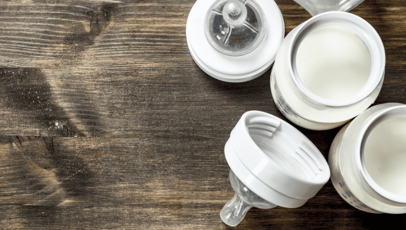 top-down-view-of-baby-bottles-on-a-wooden-table