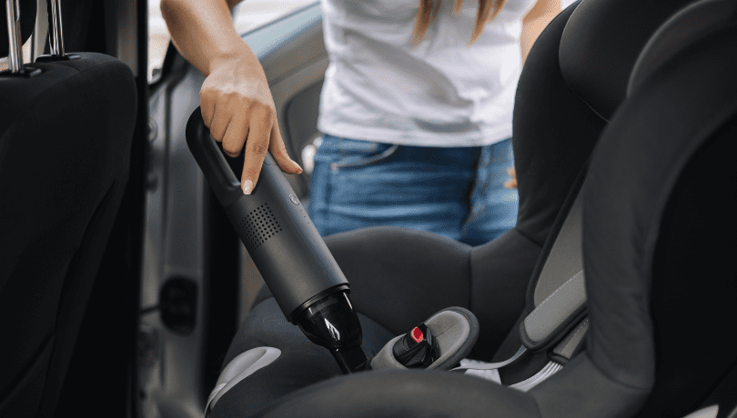 woman-vacuuming-infant-car-seat