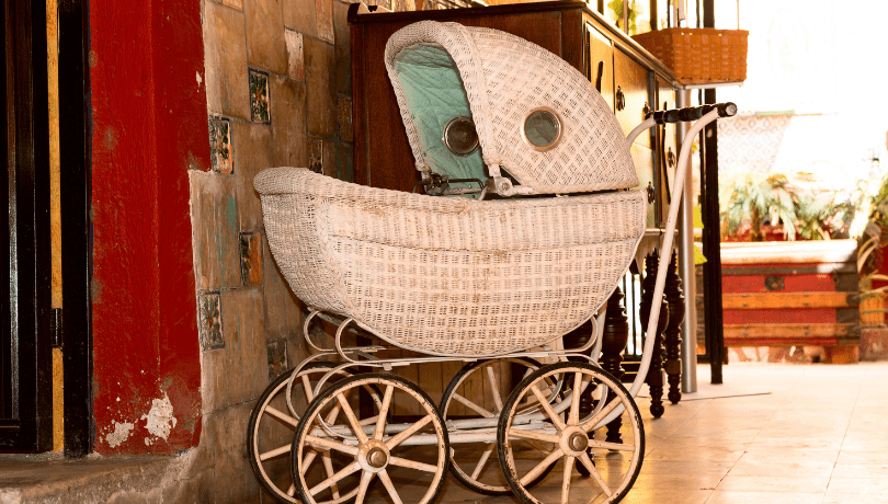 old-fashioned-white-stroller-parked-in-a-vintage-looking-room
