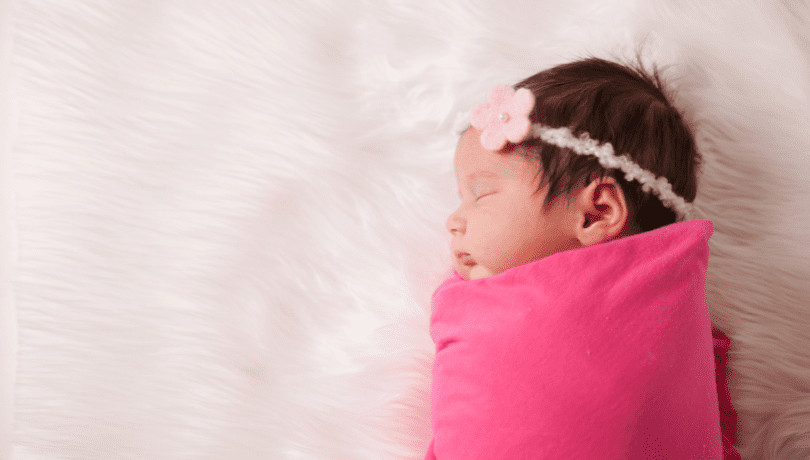 cute-newborn-baby-sleeping-while-swaddled